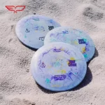 Frisbee Yikun Disc-Golf Distance Driver XIHE Inner Color - Modèle A frisbees posés sur le sable